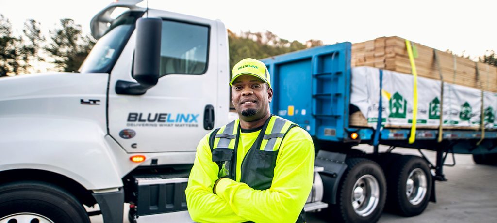 bluelinx employee in front of a bluelinx truck